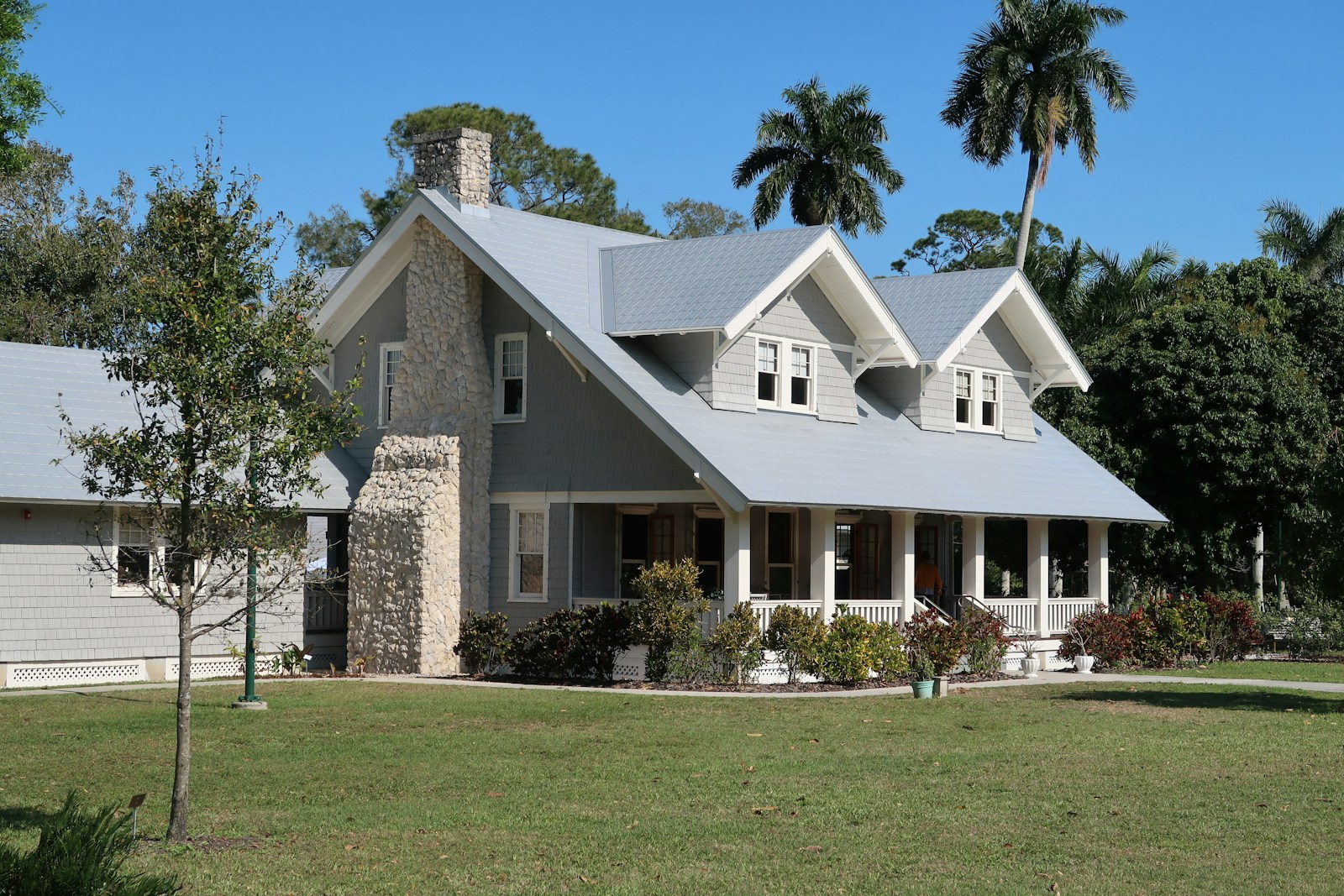 home brown and white concrete house near green grass field during daytime home
